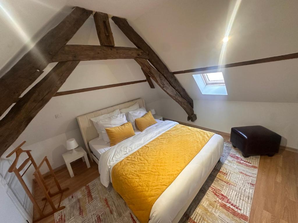 a bedroom with a large bed in a attic at Le loft sous les colombages in Gouffern en Auge