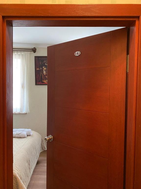 a door leading into a bedroom with a bed at Kaan Pansiyon in Bartın