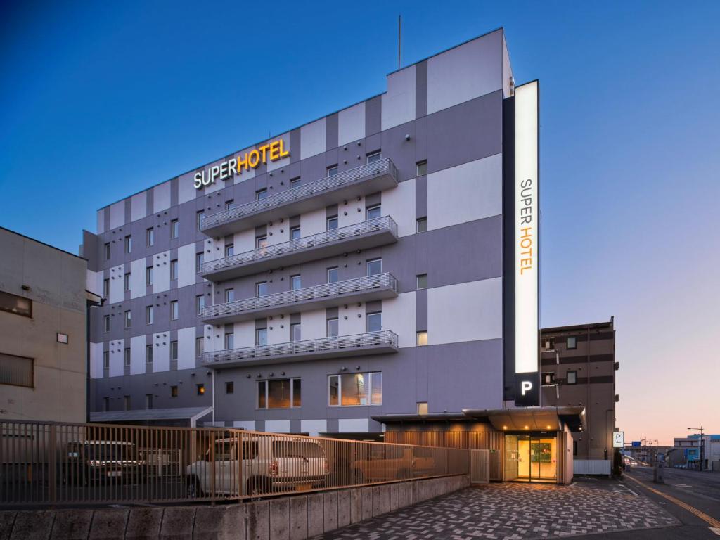 a hotel with a sign on the side of it at Super Hotel Morioka in Morioka