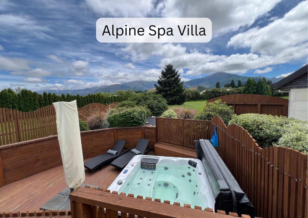 a patio with a hot tub on a deck at Vibrant Living Retreat in Hanmer Springs