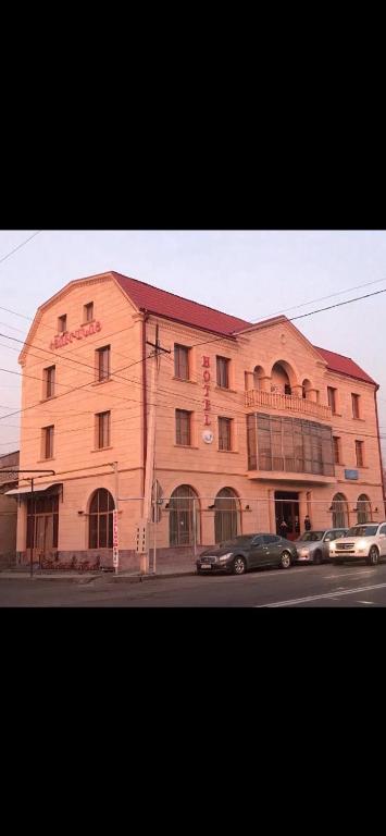 a large building with cars parked in front of it at DAVID Hotel in Yerevan