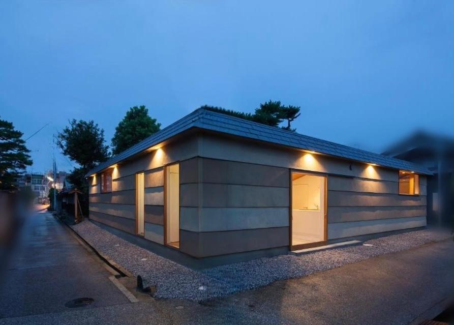 a small building with lights on the side of it at GuesthouseMuga in Hikone