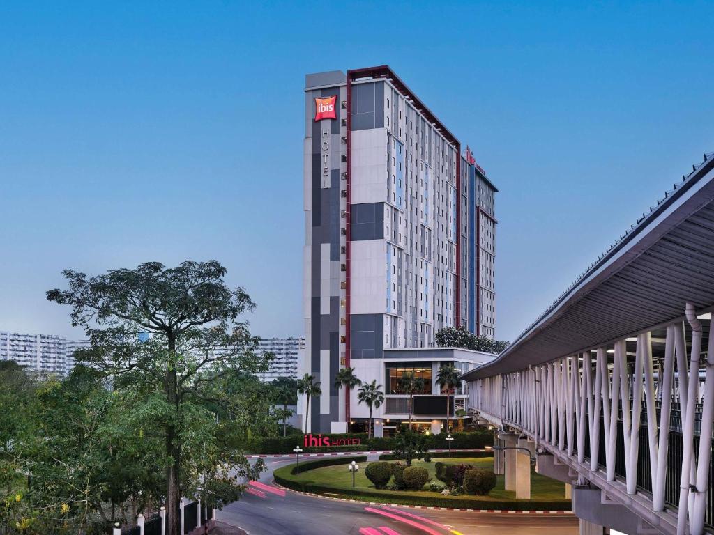 a rendering of a tall building next to a street at ibis Bangkok IMPACT in Nonthaburi