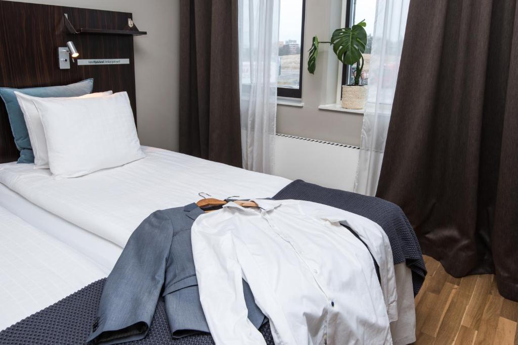 Postel nebo postele na pokoji v ubytování Hotell Fyrislund