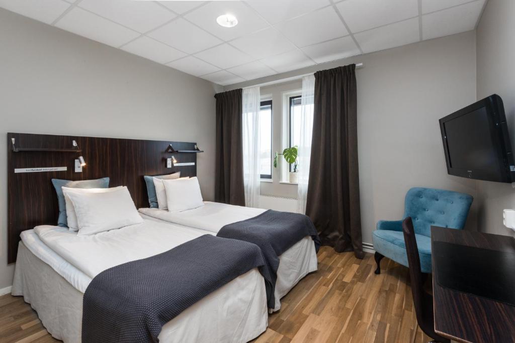 Postel nebo postele na pokoji v ubytování Hotell Fyrislund