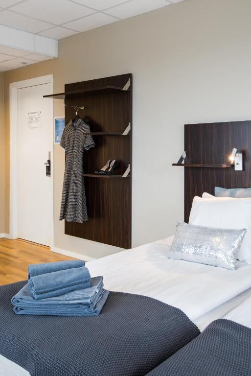 Postel nebo postele na pokoji v ubytování Hotell Fyrislund