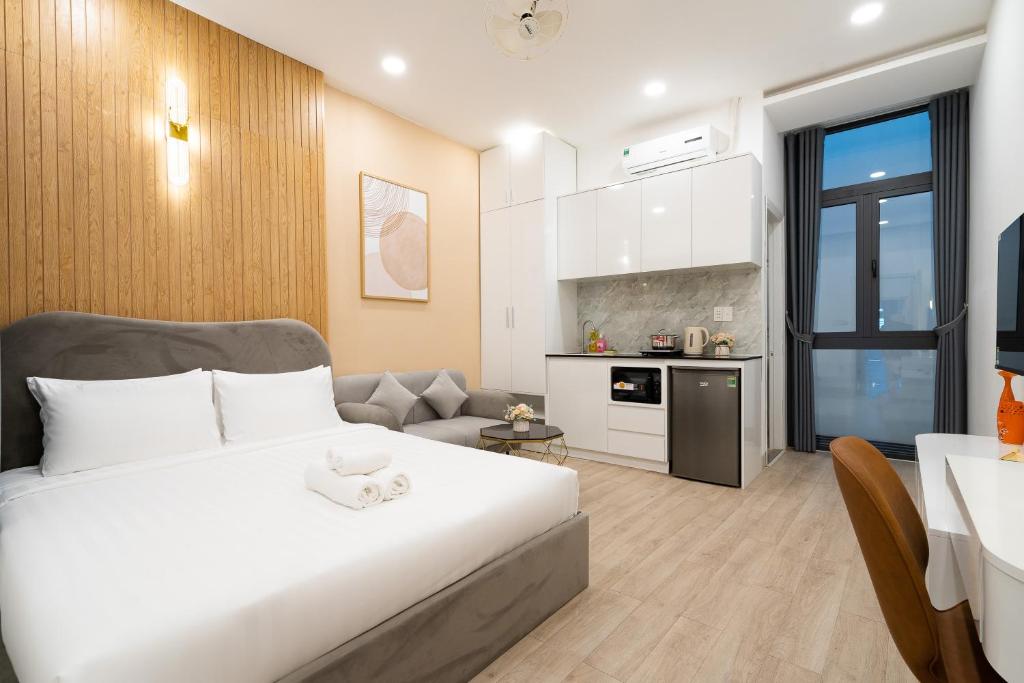 a bedroom with a bed and a living room at Misa House - Starlit Saigon in Ho Chi Minh City