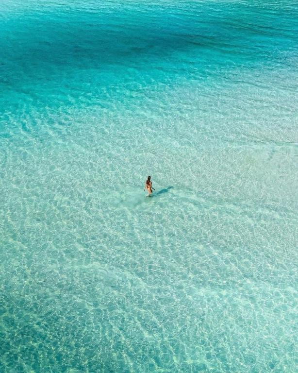 a person on a surfboard in the water at Amor Resort Koh Rong in Koh Rong Island