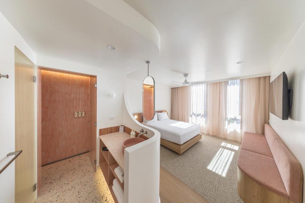 a hotel room with a bed and a tv at Bounce Surfers in Gold Coast