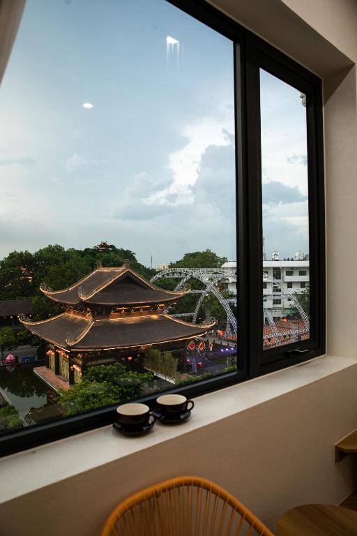 a window with a view of a chinese temple at Trang An Harmony Hotel in Ninh Binh