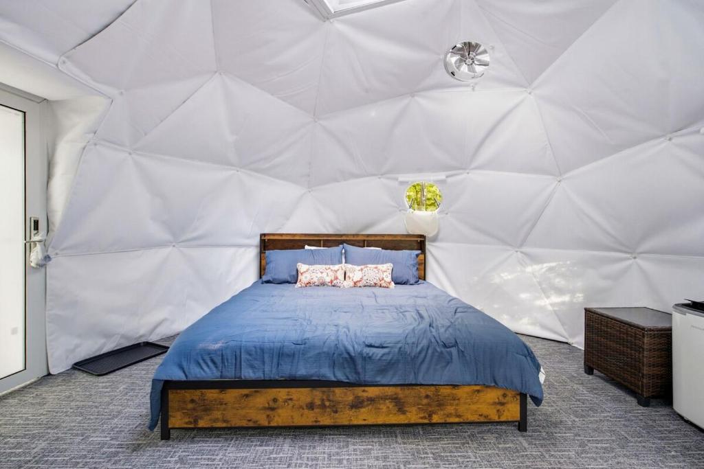 a bedroom with a bed in a dome tent at Pleasant River Glamping Dome 3 King bed in Bethel