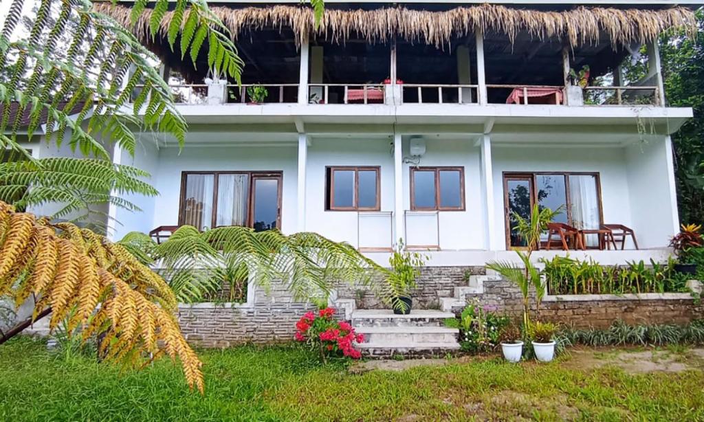 a white house with plants in front of it at A'Resta Samasta Green Lodge in Praya