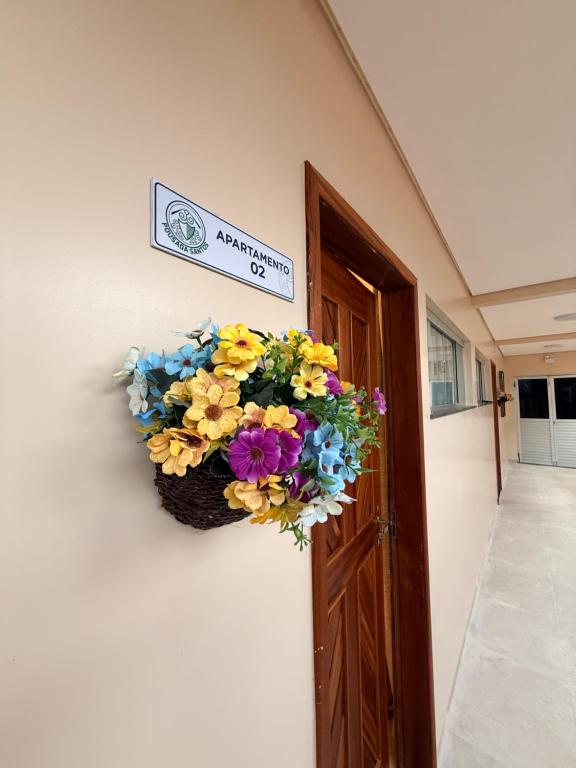 a wreath of flowers on the side of a door at Pousada Santos in Parintins