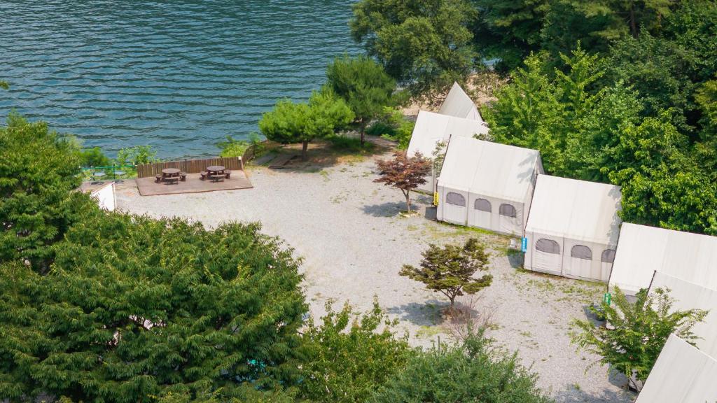 an aerial view of a building on the shore of the water at Gapyeong 516geullaemlaban in Gapyeong
