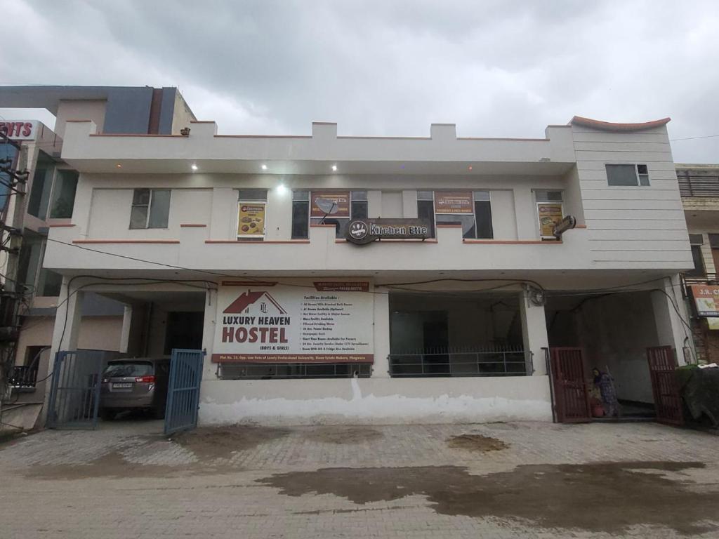 a large white building with a sign in front of it at Luxury Heaven Hostel For Couples, Students, Faculties, Corporates in Chaheru