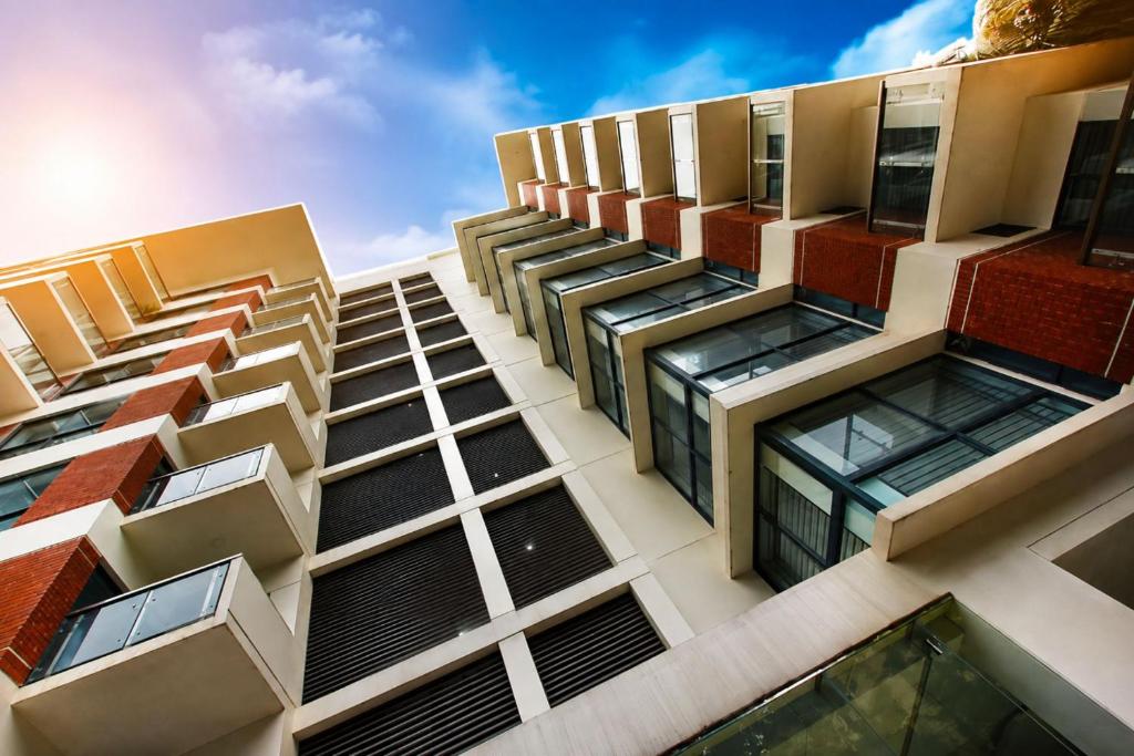a tall building with many windows on it at Spring Hill Service Apartments in Dhaka