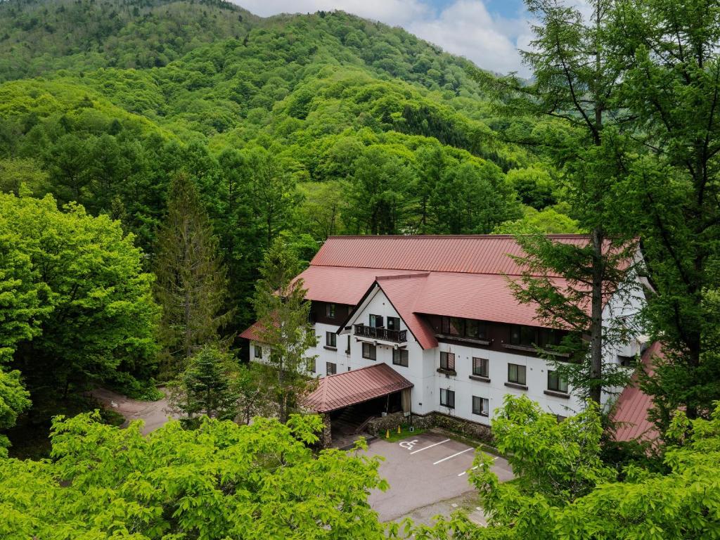 an aerial view of the inn with mountains in the background at Wan Wan Paradise Takayama in Takayama