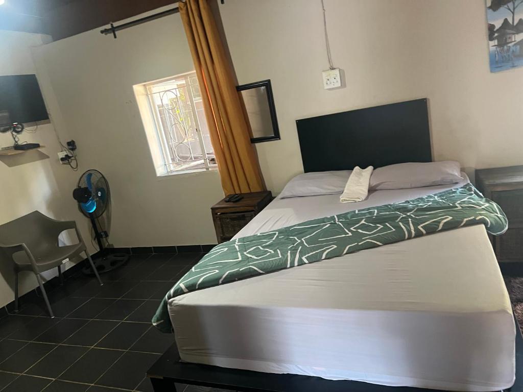 a bedroom with a bed in a room at Happy Time guest house in Phalaborwa