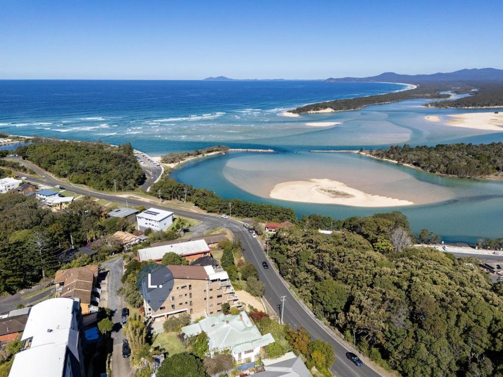 an aerial view of a beach and water at Ocean Retreat in Nambucca Heads