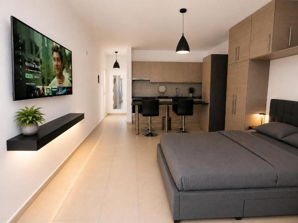 a living room with a bed and a kitchen at Maison Amalthea in Limassol
