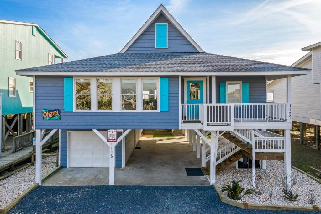 a blue house with a gambrel roof at Ohana in Holden Beach
