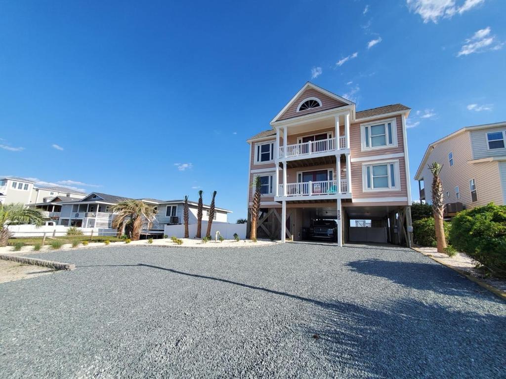 a driveway in front of a house at Ohana Tides Home in Holden Beach
