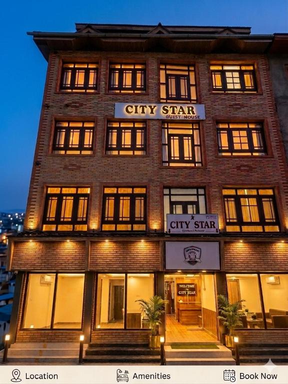 a tall brick building with a citystar city star sign on it at City Star in Srinagar