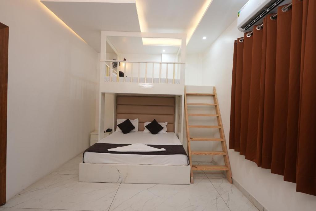 a small bedroom with a bunk bed and a staircase at hotel baromas retreat in Jawālāpur
