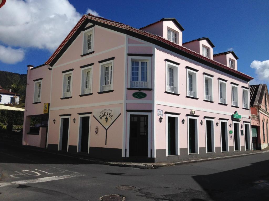 a large white building on the side of a street at Hotel Vale Verde in Furnas