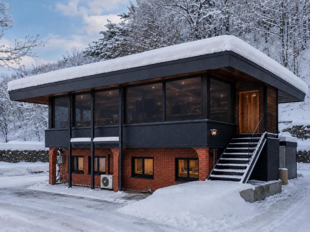 a house with snow on top of it at Jaune Chalet in Hakuba
