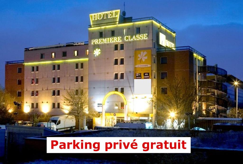 a hotel building with the words parking prize grille at Premiere Classe Paris Ouest - Nanterre - La Defense in Nanterre