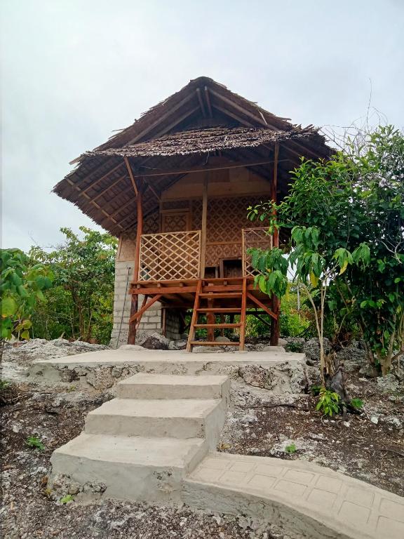a small hut with a table and some stairs at Kampa Lodge in Tano