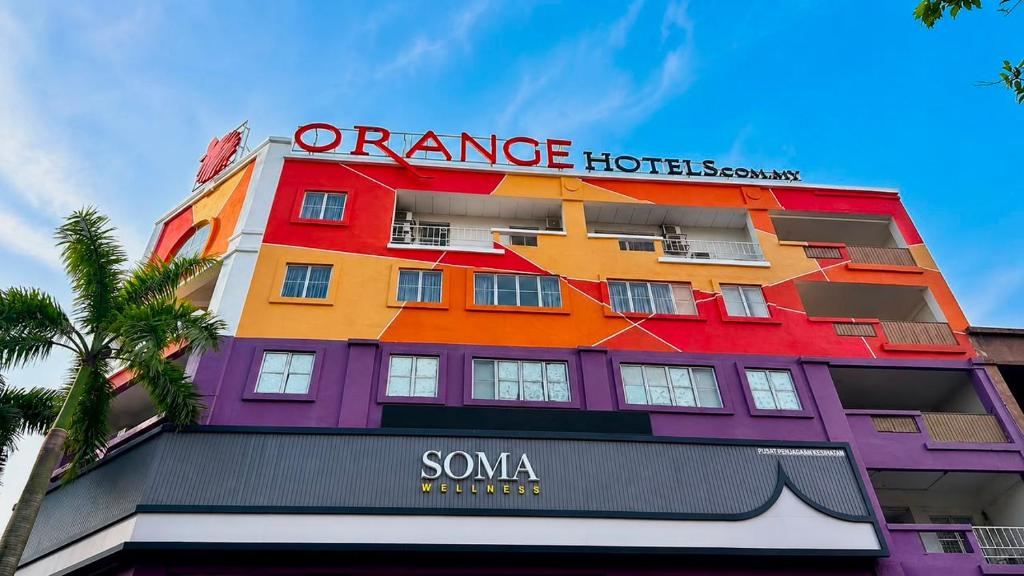 a building with an orange hotel sign on it at Orange Hotel Kota Kemuning @ Shah Alam in Shah Alam