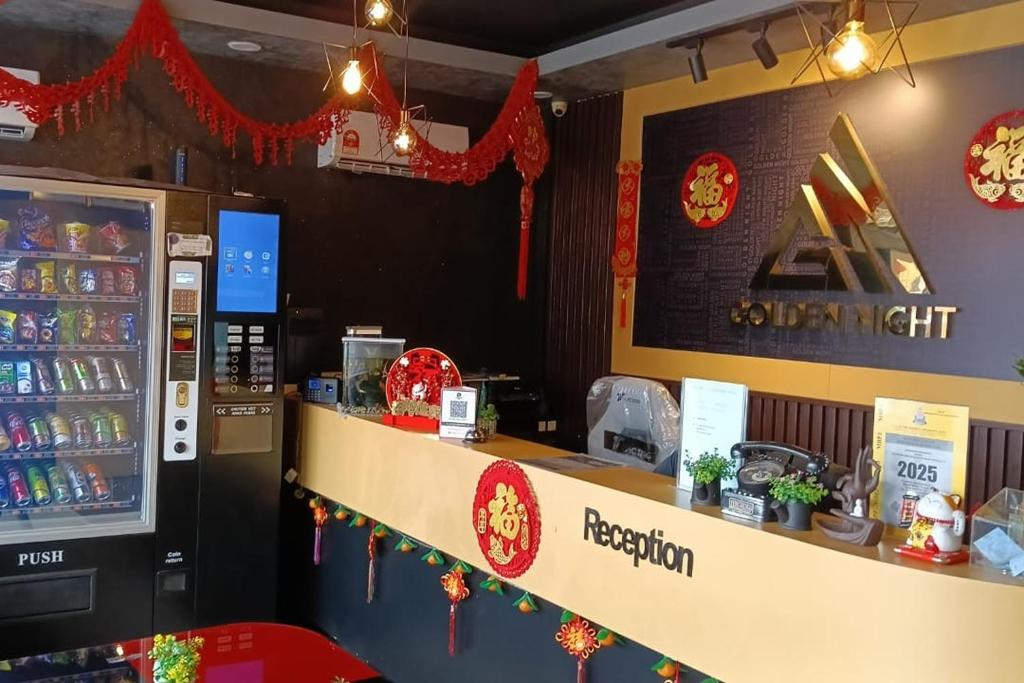 a restaurant with a cash counter and a refrigerator at Golden Night Hotel Sunway in Petaling Jaya