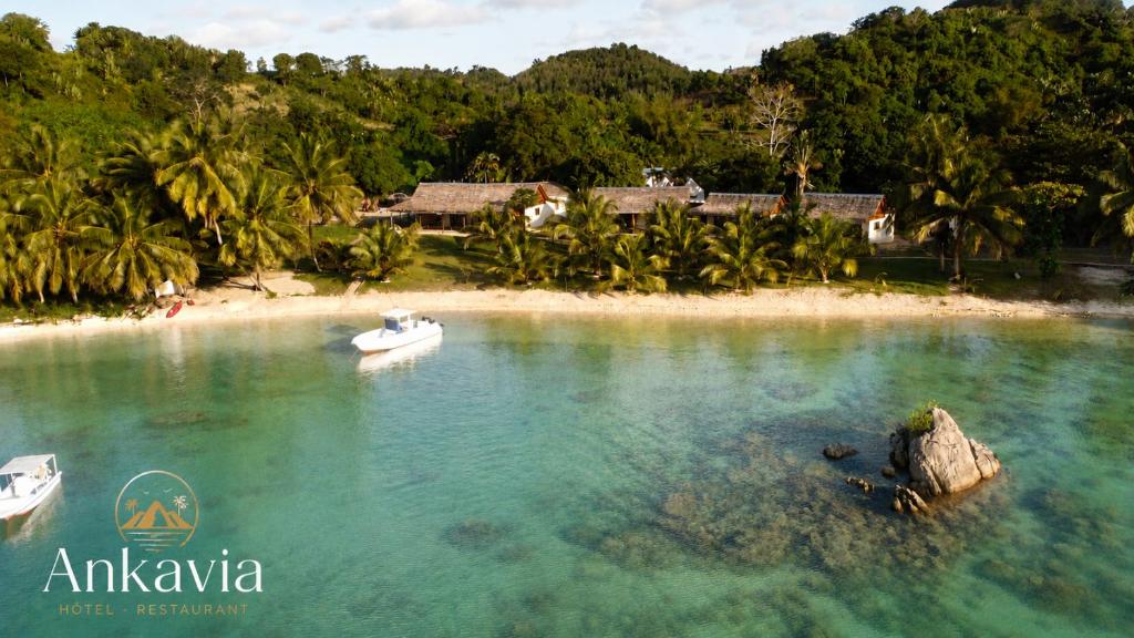 an island with two boats in the water at Ankavia Lodge in Sainte Marie
