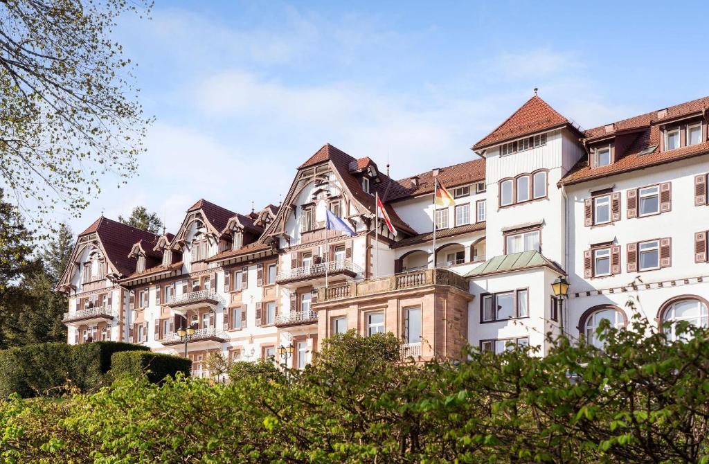 a large white building with a roof at Das Palmenwald Schwarzwaldhof, BW Signature Collection in Freudenstadt