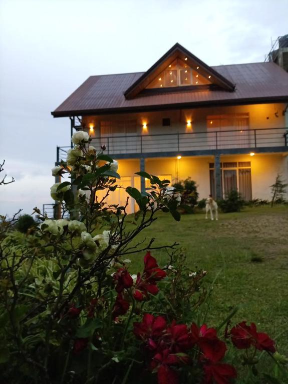a house with a dog in front of it at Skye in Hortons in Pattipola