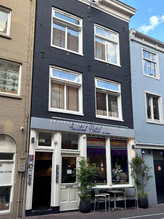 a black building with akritkrit trial on the street at Amistad hotel in Amsterdam