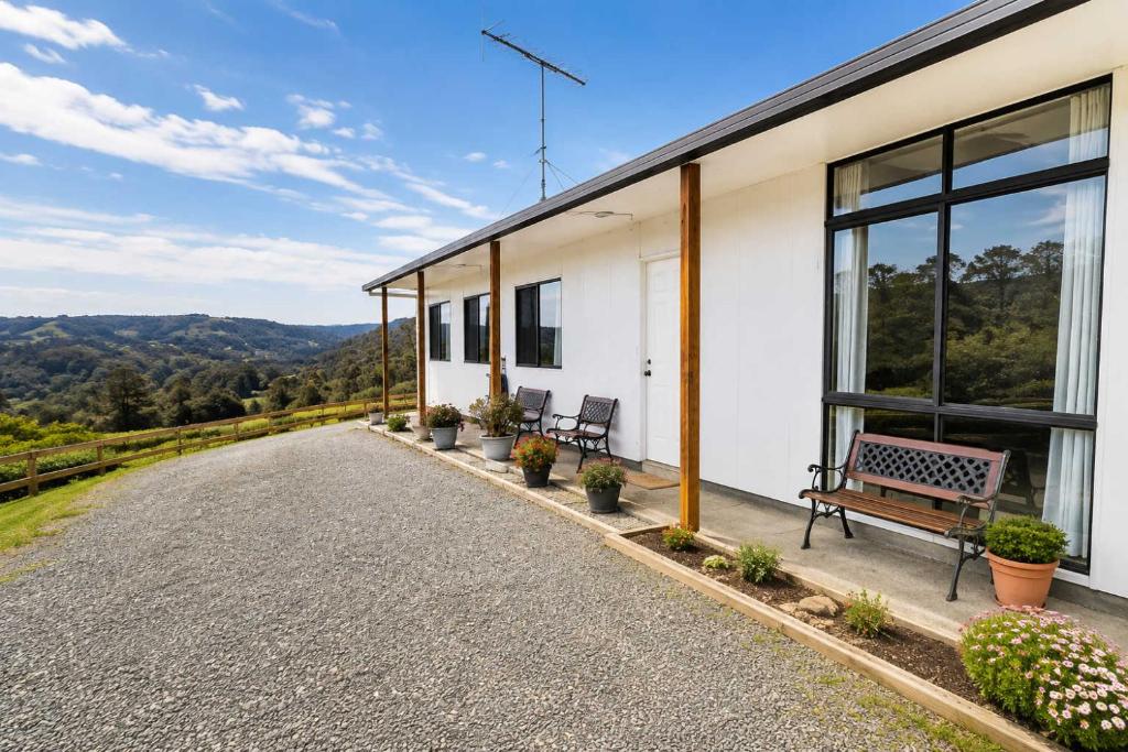 a house with a bench on the side of a road at The Aurora House - BBQ Firepit Stargazing in Tea Tree