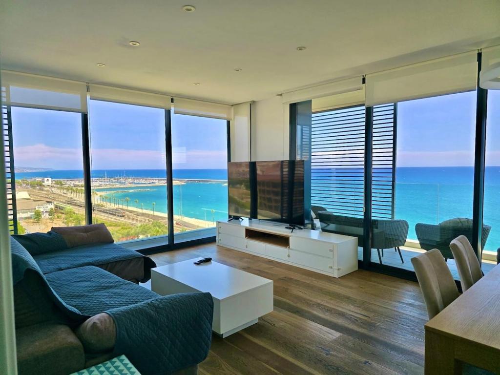 a living room with a view of the ocean at Beachfront with pool and great views in Mataró