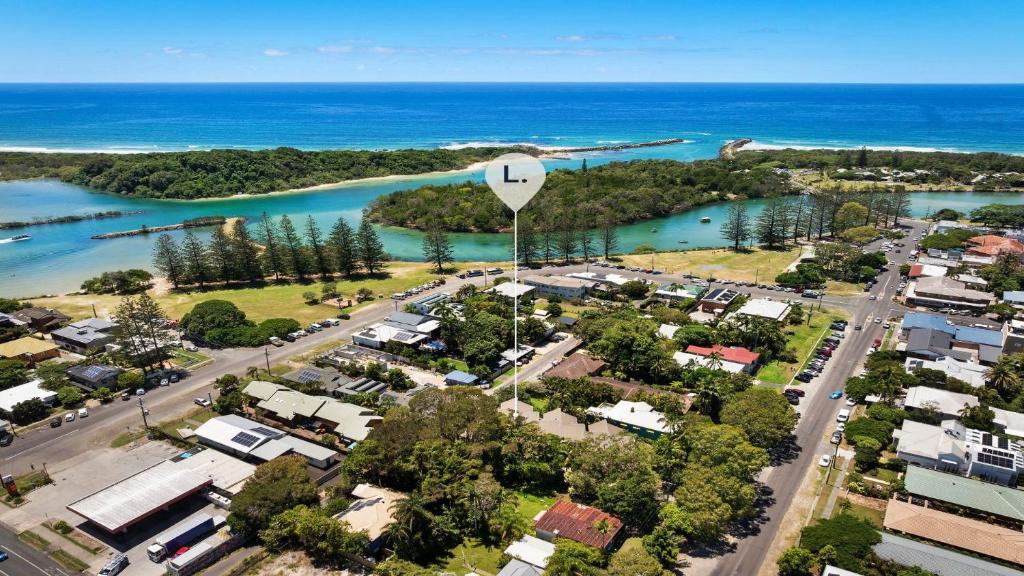 an aerial view of a city with a harbor and the ocean at Brunswick Palms 1 in Brunswick Heads