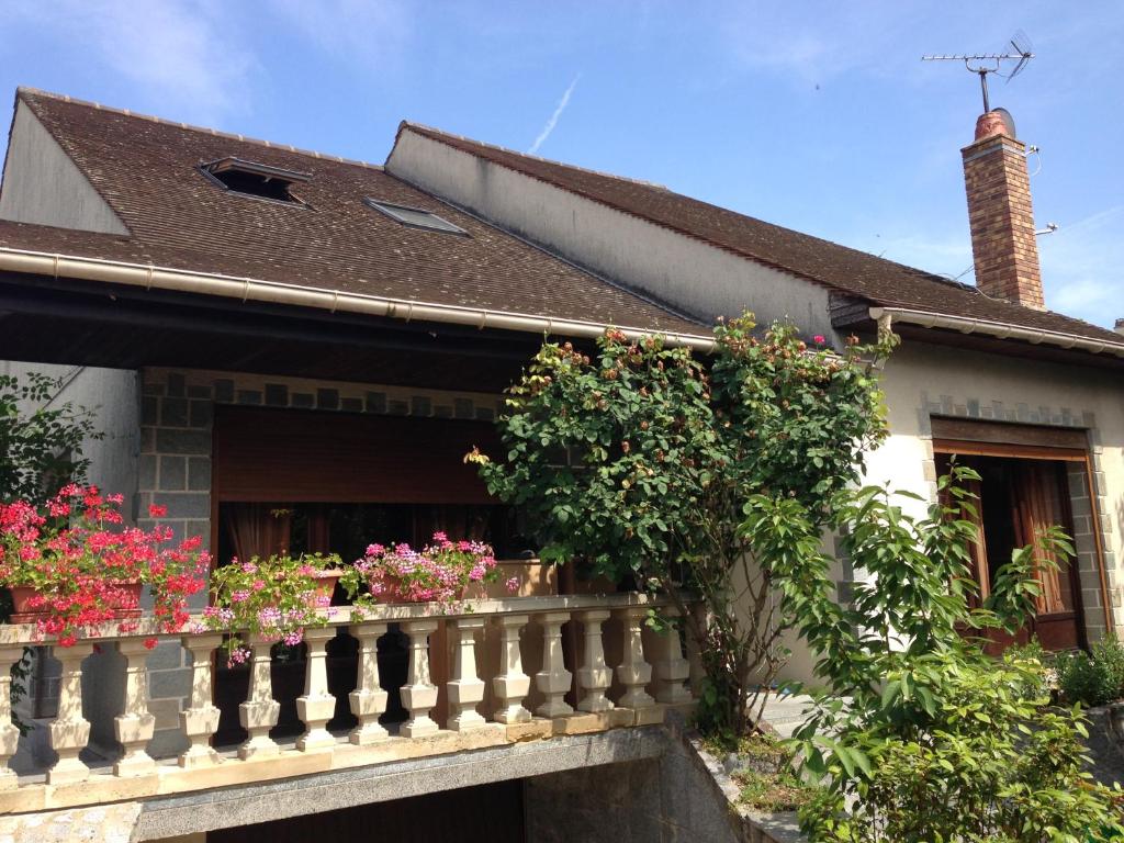 een wit huis met bloemen op een balkon bij Appartement indépendant chez l'habitant in Bezons