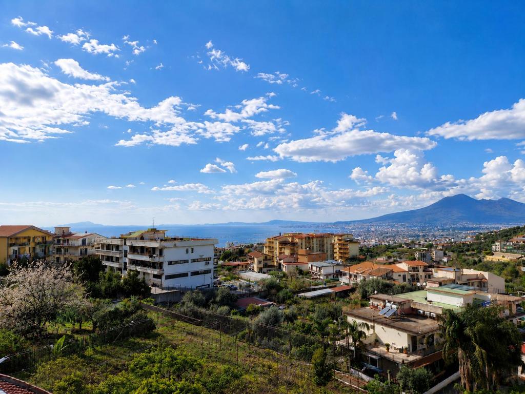a city with buildings and a blue sky with clouds at Verso Maison in Gragnano
