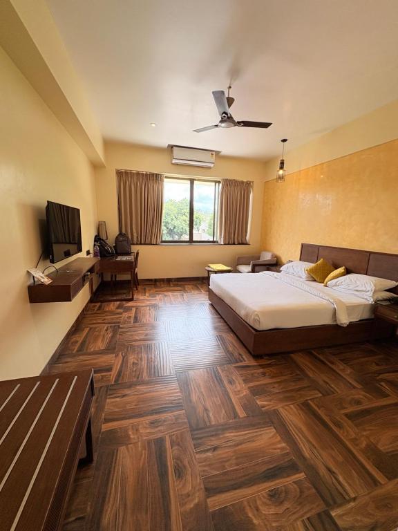 a bedroom with a bed and a television in it at Jj Internatinals Group in Bhopal
