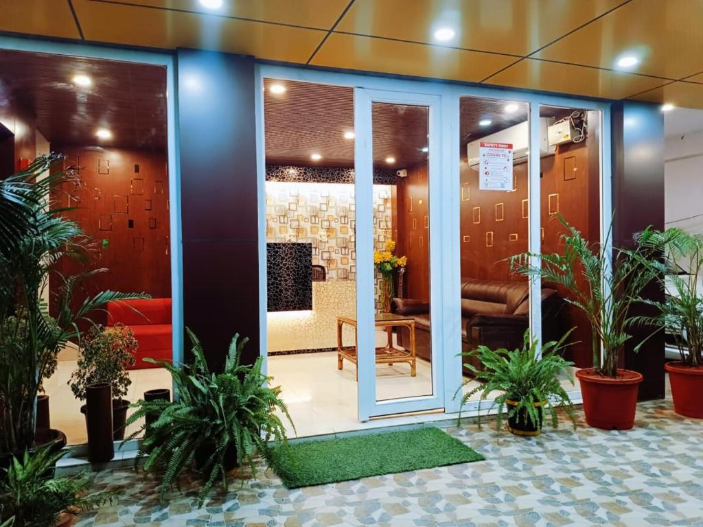a lobby with potted plants in a building at The Mangrove Cove "200Mtrs from Beach" in Shādipur