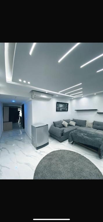 a living room with couches and a couch and a tv at بورتو السخنه الاهرامات in Ain Sokhna