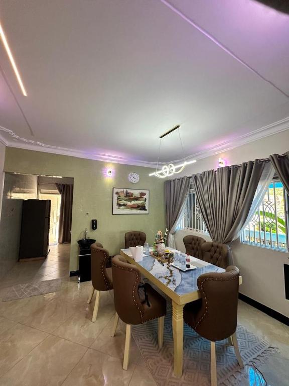 a living room with a dining room table and chairs at Ashland Gardens in Vumba