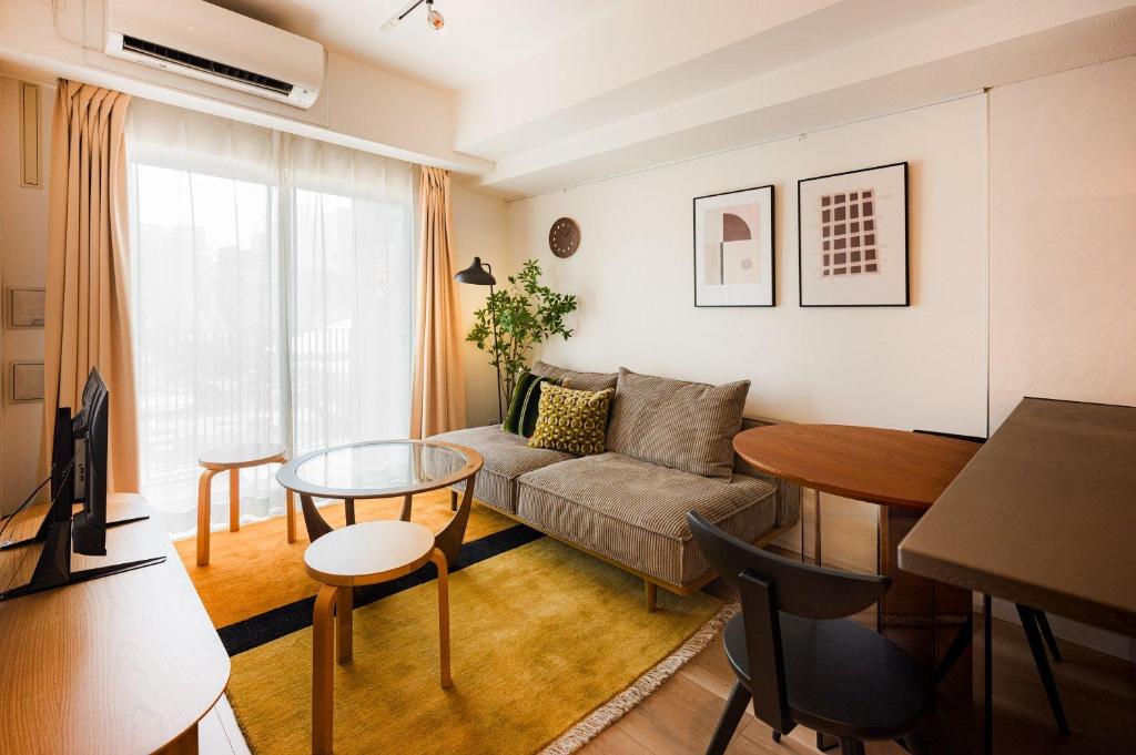 a living room with a couch and a table at Creazione Akasaka in Tokyo