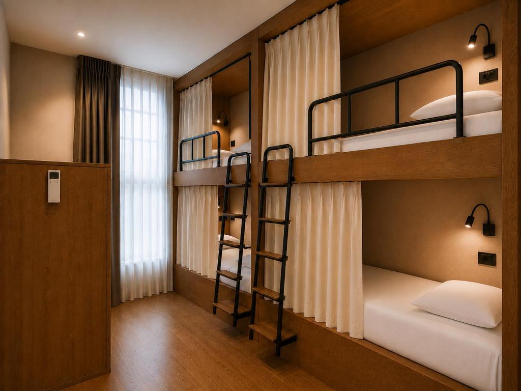 a room with two bunk beds and a window at Welcome Hostel in Churriana