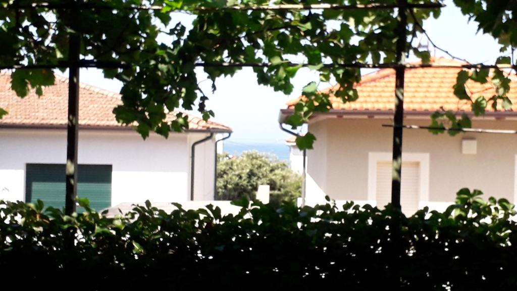 a white house with a view of the ocean at A garden on the bay in Castiglioncello